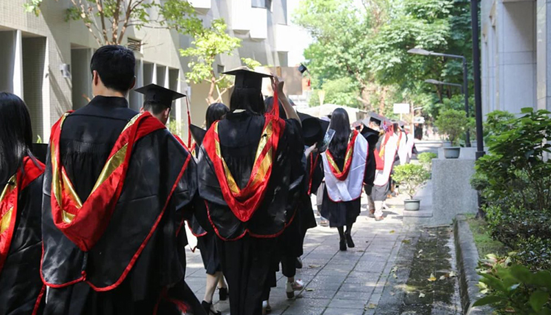 photo of college graduates walking away from the camera