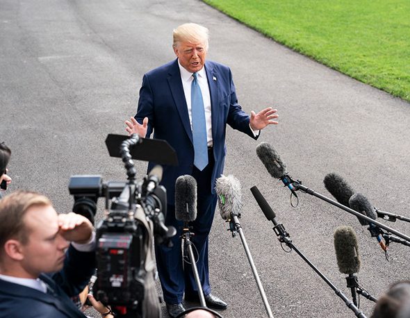 President Donald Trump talks to members of the press on the South Lawn of the White House. October, 2019.